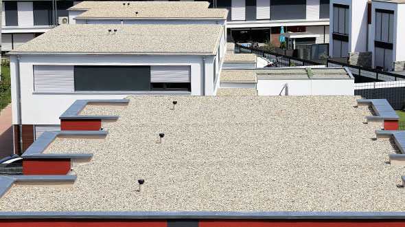 Gravel used to surface a BUR roofing system