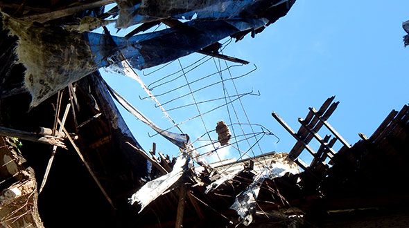 Damaged commercial roof collapse