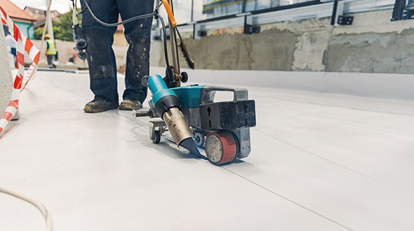commercial roofing crew installing TPO membrane installation