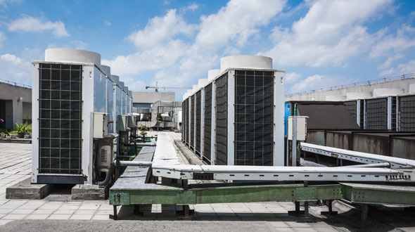 Commercial roofing system elevated walkway between air conditioning units