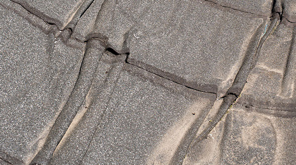 Modified bitumen roofing damaged from severe weather and temperature conditions