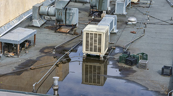 Equipment on commercial roof contributing to an impending collapse