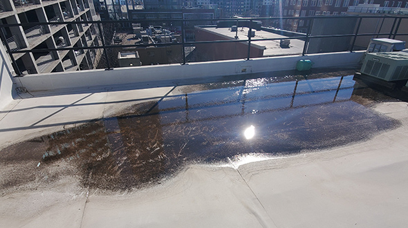 ponding water on a flat roof causing material deterioration