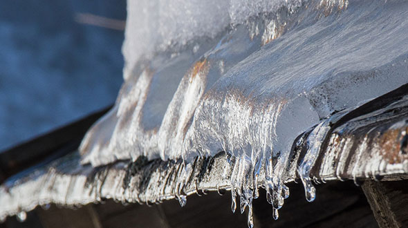 Ice dams on commercial roofing in winter time