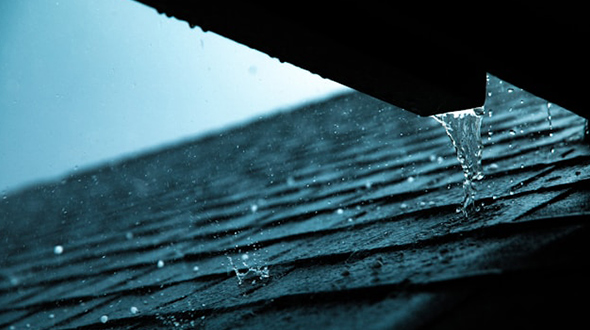 shingle roof experiencing a rain storm