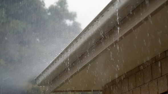 Stopping a roof leak in the rain can mean clearing your gutters so water can flow away from your roof