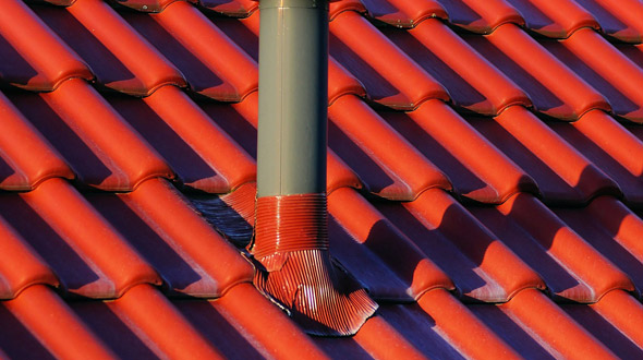 Commercial roof vent penetration with flashing