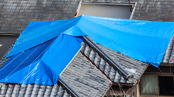 Stopping a roof leak in the rain may require you to tarp it until professional help can permanently fix it