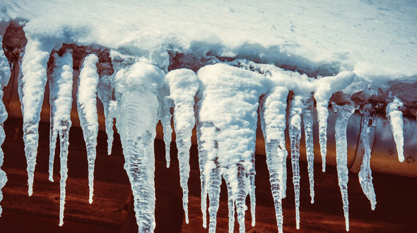 Roofing system eaves and gutter with ice dams