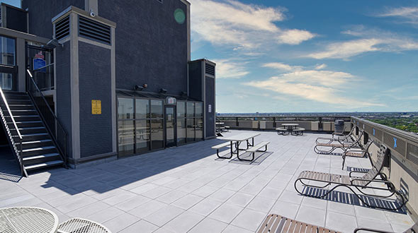 Commercial rooftop deck with lounging furniture and tables